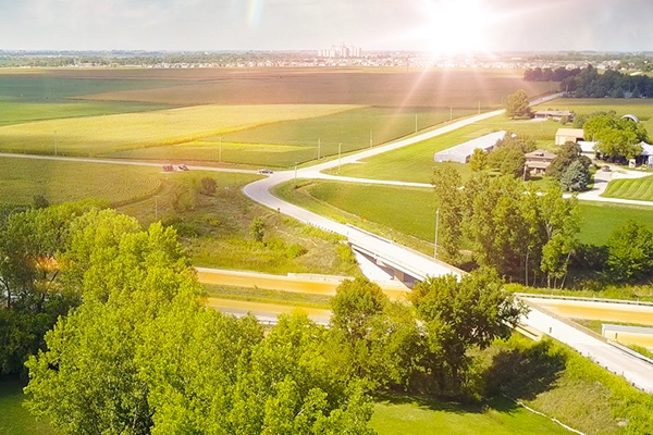 Industrial worker with helmet, sparks flying near tool and four final plats totaling 21 new lots and 90.72 acres.